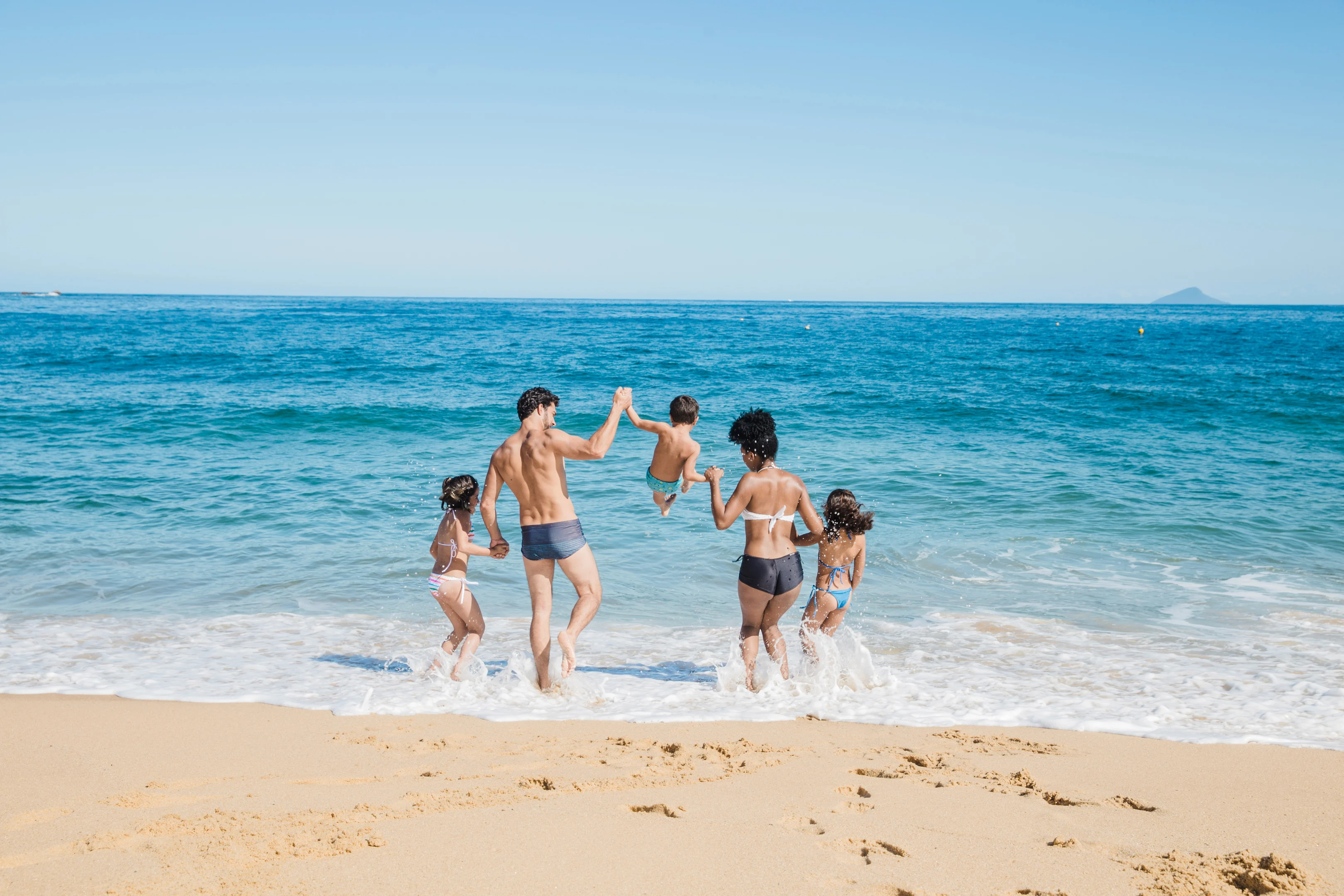 Family playing in the surf at the beach